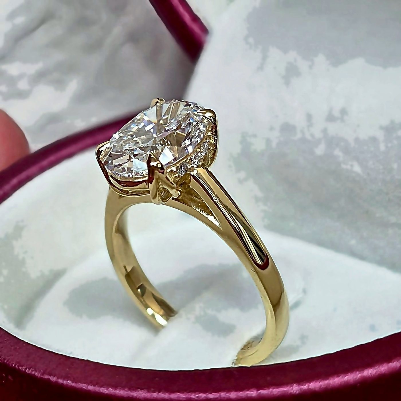 Hidden Bloom oval diamond ring in 18k yellow gold tulip setting