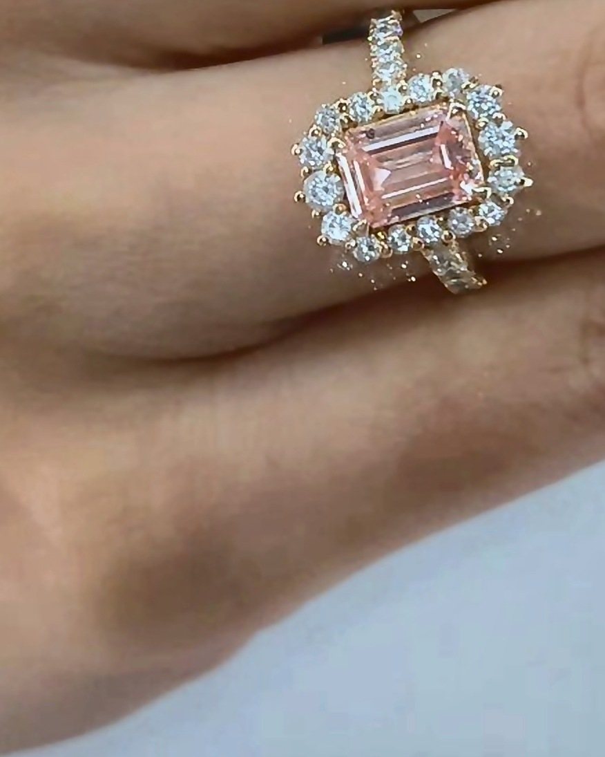 Pink emerald-cut diamond halo ring design example